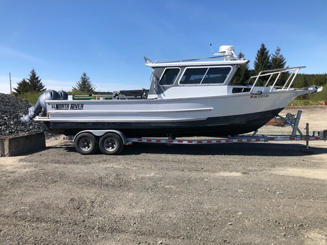 Aluminum boat on trailer awaiting hull inspection