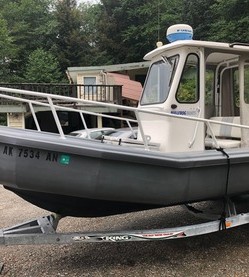 Aluminum workboat on trailer near boat shed, Juneau AK